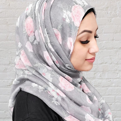 Floral hijab in grey with pink and white flowers in a thin fabric perfect for summer hijab